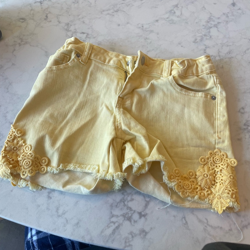 These are yellow flower designed Jean shorts